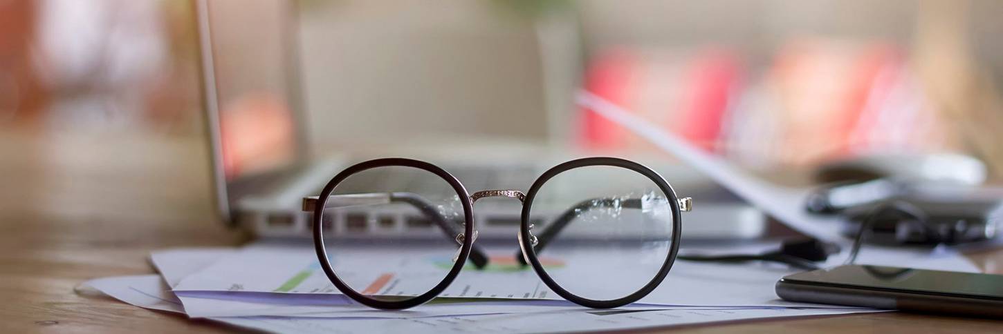 Close-up of Eyeglasses on Desk_Issarapong Suya_GettyImages-728872683